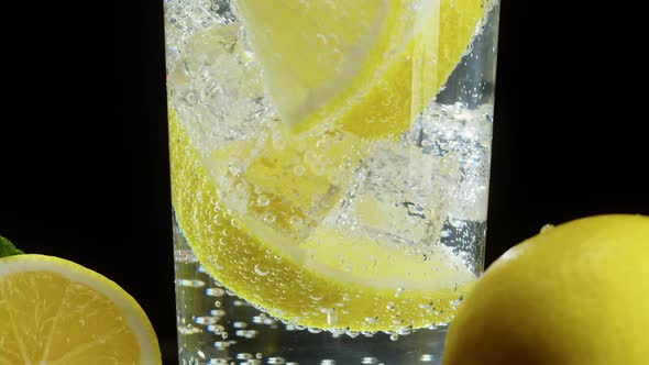 Making Lemon Cocktail on Black Background