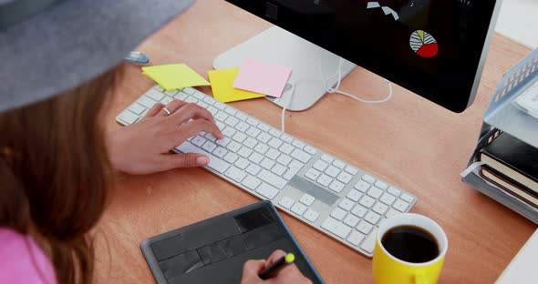 Female graphic designer working at desk 4k