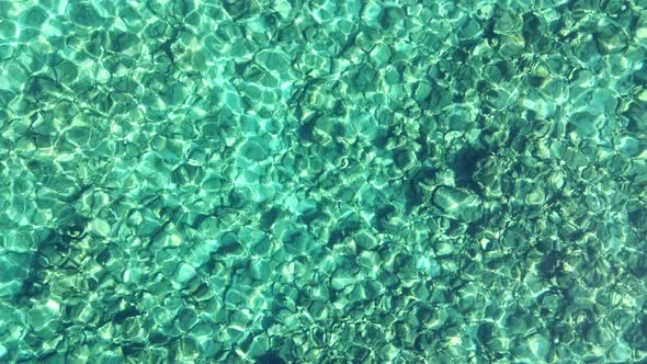 Top view of transparent shallow turquoise ocean sea water surface