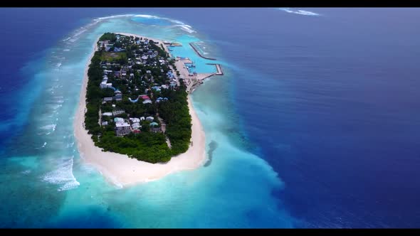 Aerial drone shot travel of paradise coastline beach break by blue green sea and white sandy backgro