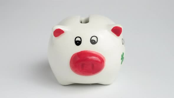 Money is put into the piggy bank. Piggy bank filled with dollar bills. Piggy bank with money. 