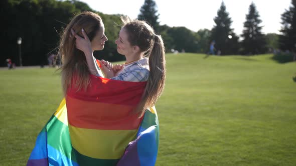 Young Gay Couple Standing Wrapped in Lgbt Flag