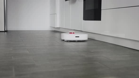 Robot Vacuum Cleaner Cleans a Modern Apartment