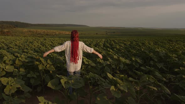 Slow Motion of a Girl with Red Hair That Raises Her Hands Up