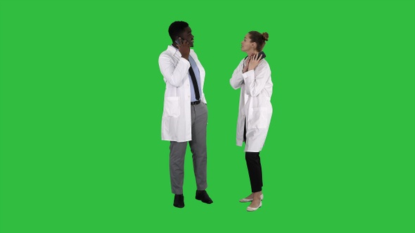 Female and male doctor using mobile phones making calls