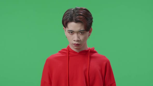 Terrible Asian Transgender Male Looking At Camera In The Green Screen Studio