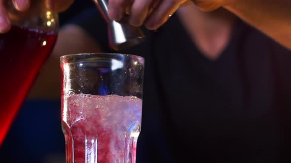 Hands of Male Bartender Preparing a Cocktail Drink and Mixes It Up