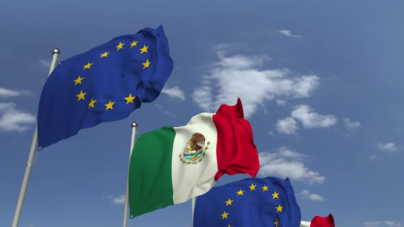 Waving Flags of Mexico and the EU on Sky Background alt