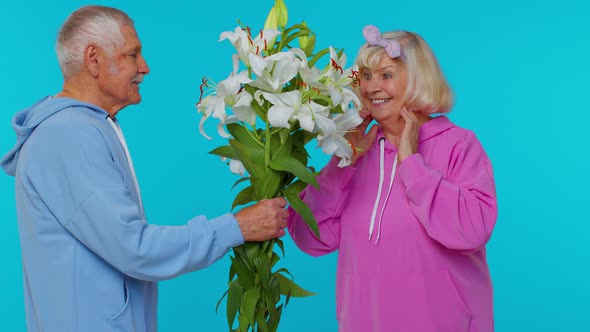 Senior Grandfather Present Bouquet of Flowers to Grandmother Happy Mature Retired Family in Old Age