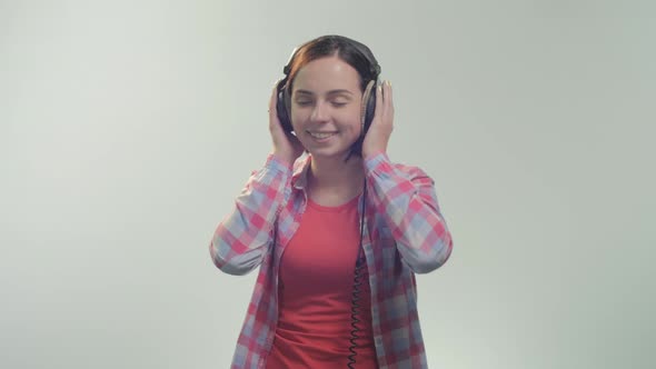 Woman listening music at the headphones