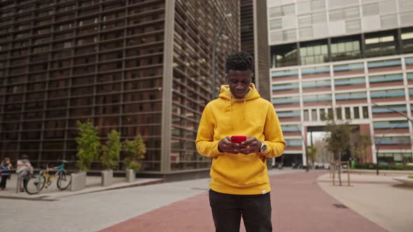 African American Man in a Downtown City Center Chatting with Cellphone