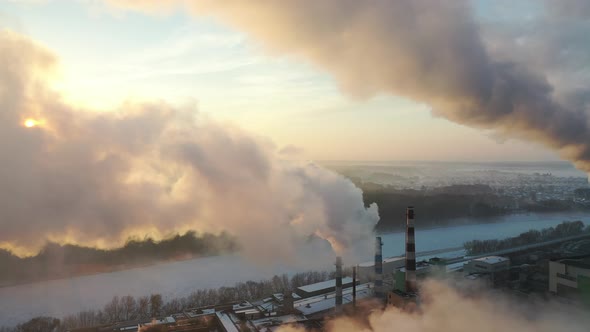 smoke from factory chimneys on the background of sunrise