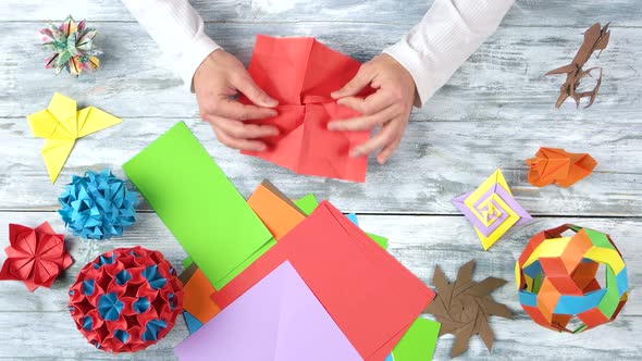 Person Making Origami Flower, Top View.