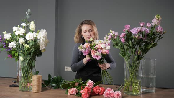 Florist Woman Composes Elegant Bouquet with Colorful Flowers