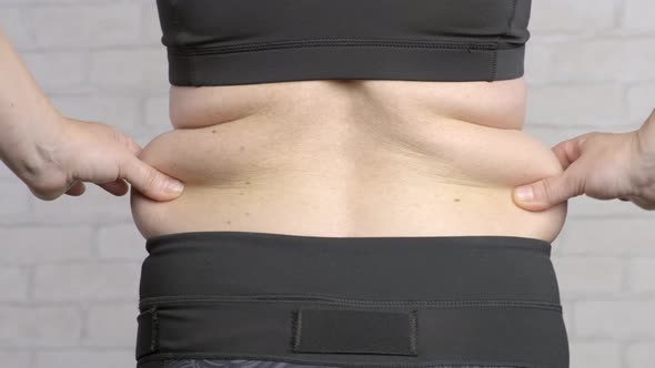 Excess fat in waist of woman.