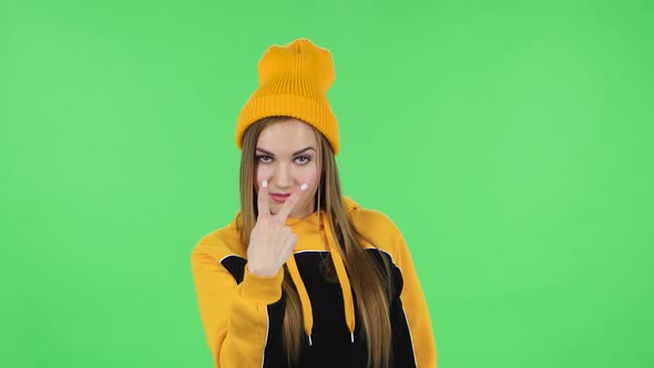 Portrait of Modern Girl in Yellow Hat Is Threatening, Showing Gestures While Looking at the Camera