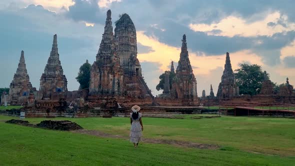 Women with Hat Tourist Visit Ayutthaya Thailand at Wat Chaiwatthanaram During Sunset