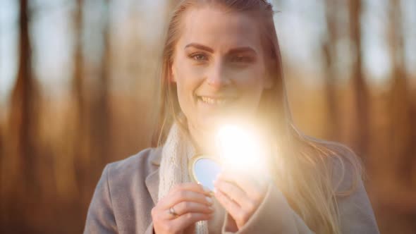 Woman Reflects Light with a Small Mirror