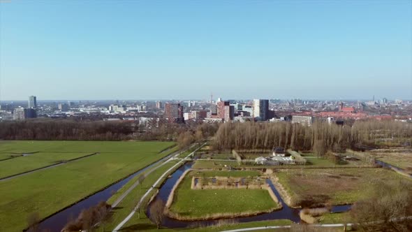 Revealing aerial shot of the edge of a city on a clear sunny day, concept for urbanization, loss of