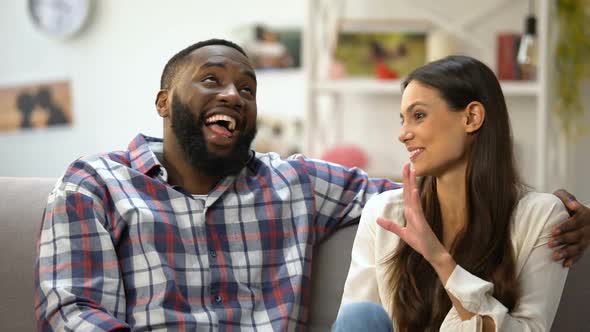 Laughing Mixed-Race Couple Joking, Having Funny Conversation, Togetherness