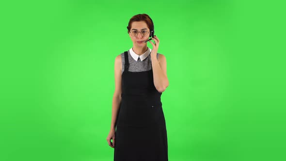 Funny Girl in Round Glasses with Headset Helping with Customer Service. Green Screen