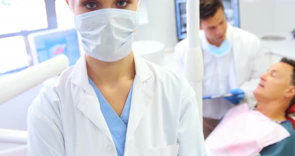 Portrait of dentist standing with arms crossed