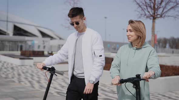 Young Man and Woman Communicate on the Street