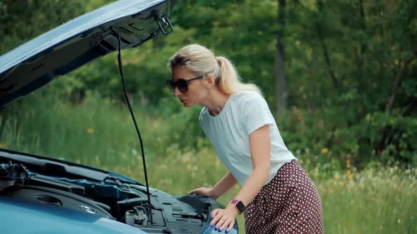 Popped Up Hood Woman Fix Car Problem. Pop Up Car Hood To Repair Damaged Auto Repair Service.