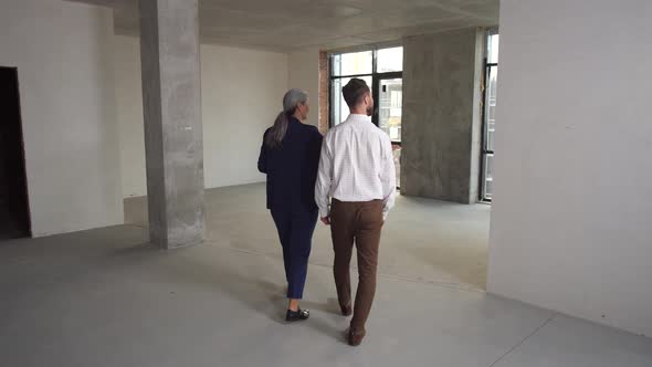 Estate Broker Showing New Empty Apartment To Buyer