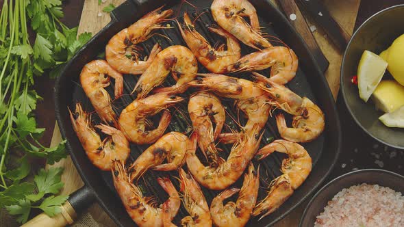 Roasted Tiger Prawns on Iron Grilling Pan with Fresh Persley, Lemon, Chilli and Bread