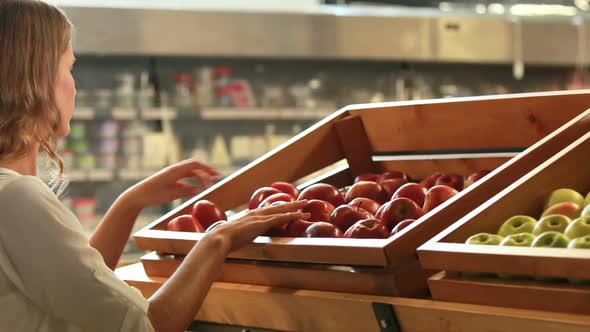 Woman Picking Out Fruit in Supermarket