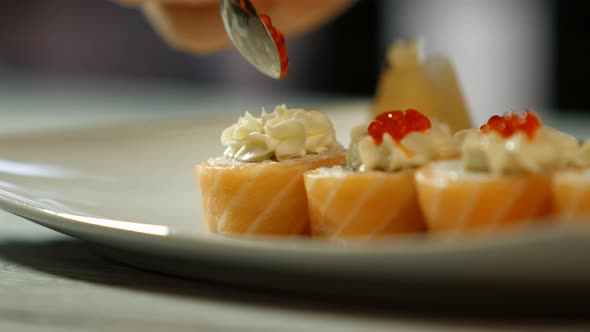 Spoon Puts Caviar Onto Sushi.