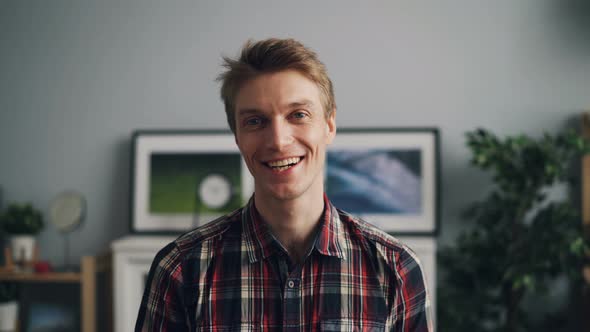 Portrait of Happy Guy in Trendy Checkered Shirt Smiling and Looking at Camera Standing