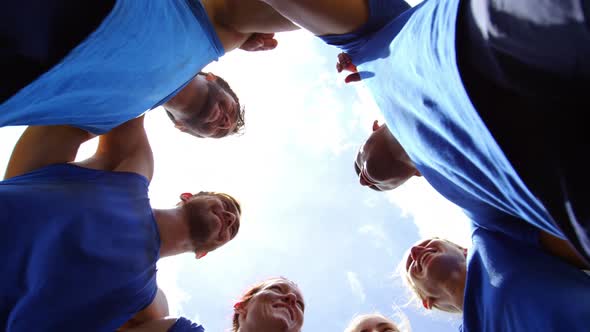 Fit people standing together and forming a hurdle 4k