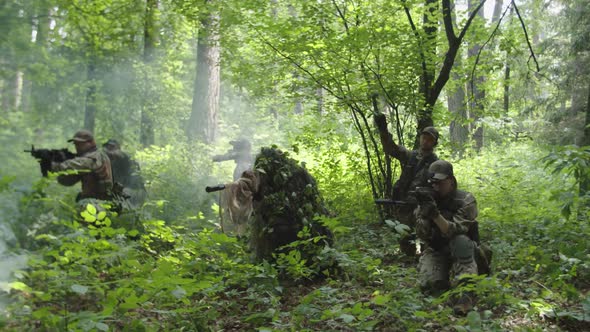 Armed Soldiers Throwing Hand Grenades Attacking Enemy Post in Forest