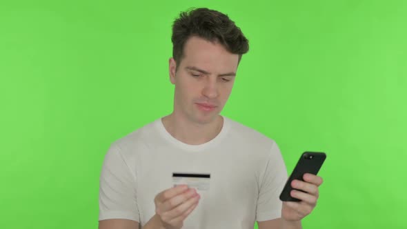Online Shopping Failure on Smartphone for Young Man on Green Background