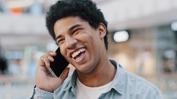 Portrait Happy African American Man Lead Carefree Conversation on Smartphone Indoors Enjoy Pleasant