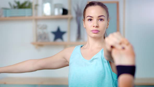 Medium Shot Beautiful Sporty Young Woman Practicing Yoga Pose During Stretching Leg Making Balance