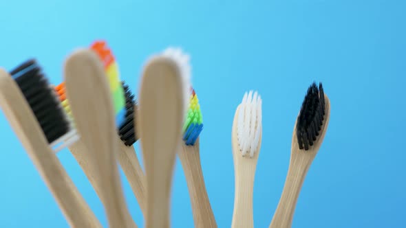 Colorful Toothbrushes Is Spinning on Blue Background