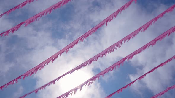 Festive Garland and Tinsel Against the Blue Sky