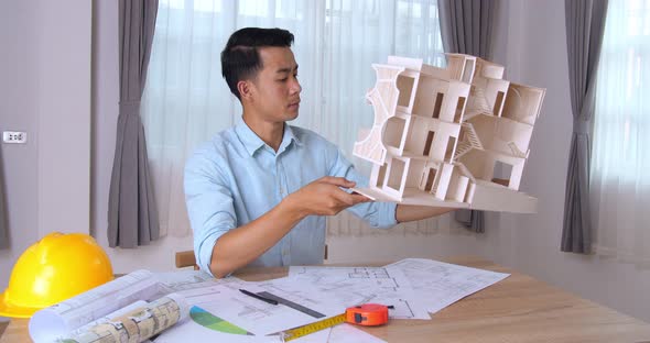 Young Architect Hold House Model And Looking  