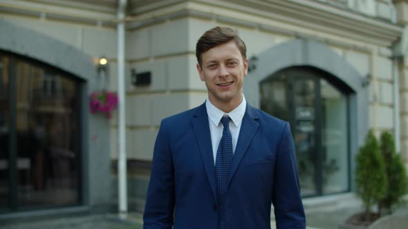 Portrait of Successful Businessman Standing at City Street. Man Showing Okay