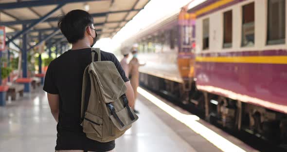 Man walking and looking the train