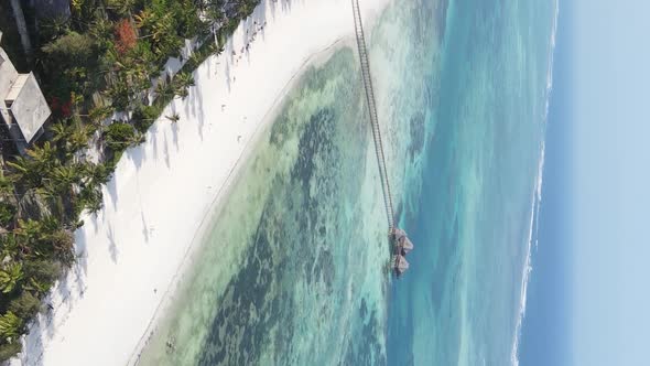 Vertical Video House on Stilts in the Ocean on the Coast of Zanzibar Tanzania Aerial View