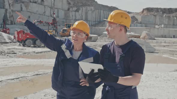 Supervisor Instructing Worker in Granite Quarry