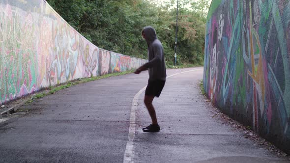 Wide Shot of Athletic Man Jumping Rope in an Underpass