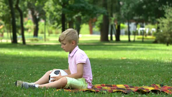 Sad Boy Sitting in Park and Throwing Ball, Lack of Friends, Victim of Bullying