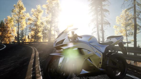 Sportbike on Tre Road in Forest with Sun Beams