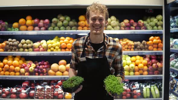 Portrait Shot of the Young Handsome Caucasian Shop Worker in the Apron Standing in Front the Camera