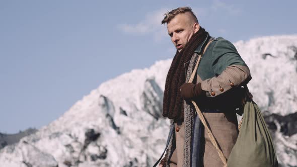 Man In Greatcoat Walking Under Clear Blue Sky